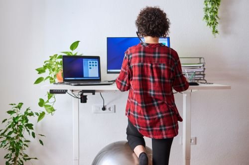 Employee working at an adapted workstation during a workplace adjustments consultancy review.