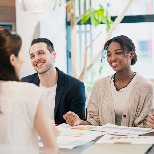 Colleagues meeting and collaborating in a professional workplace setting.