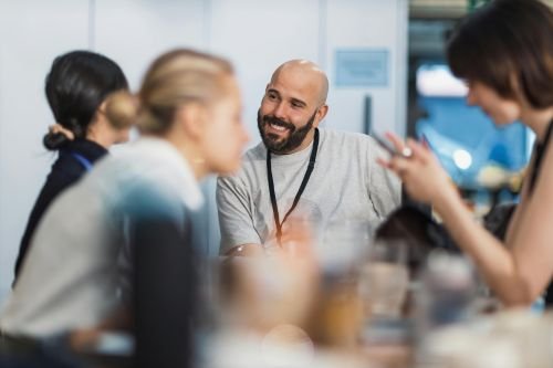 Diverse group of professionals discussing workplace inclusion and support needs in a collaborative setting.environment.